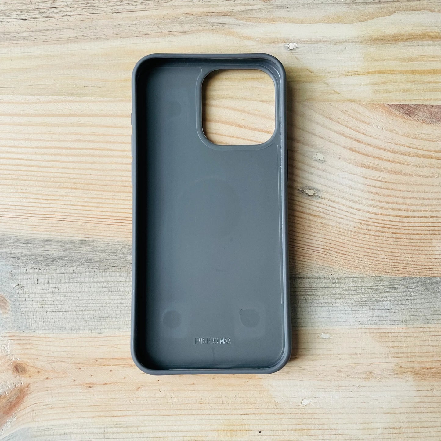 back side of Gray Series | Premium Leather 3D Embossed iPhone case on a wooden surface