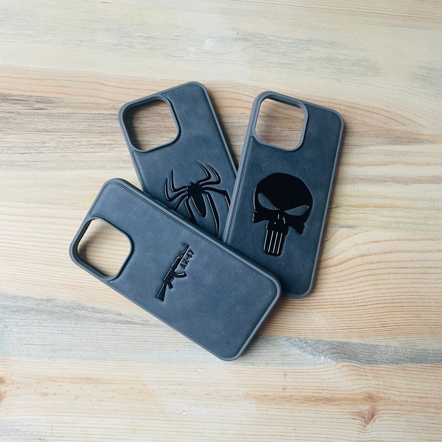 Gray Series iPhone cases full emblem style lineup on a wooden surface