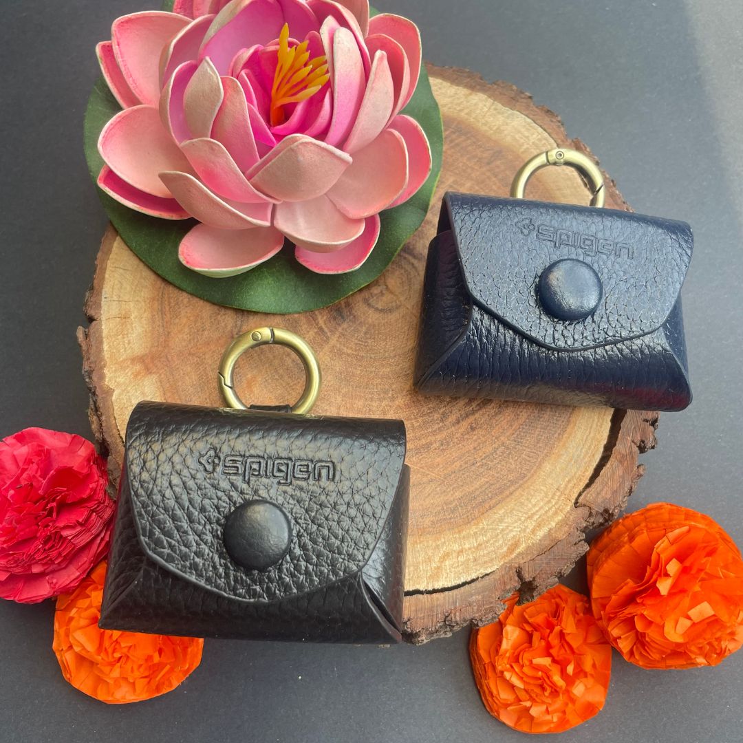 Royal leather AirPods case with golden ring attached to a bag